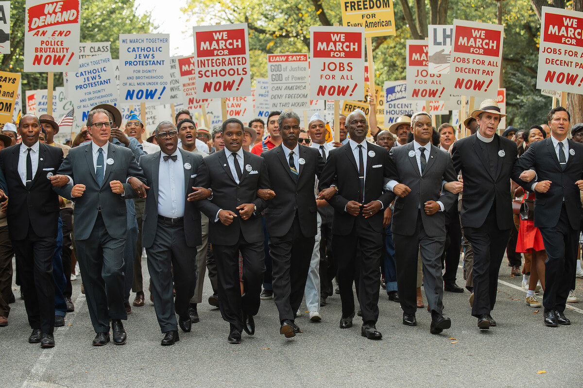 Coleman Domingo and others walking in protest in suits.