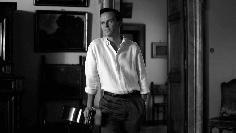 Black and white photo of Andrew Scott in a white shirt staring inside.