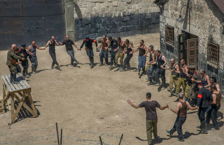 Prison inmates forming a circle dancing.