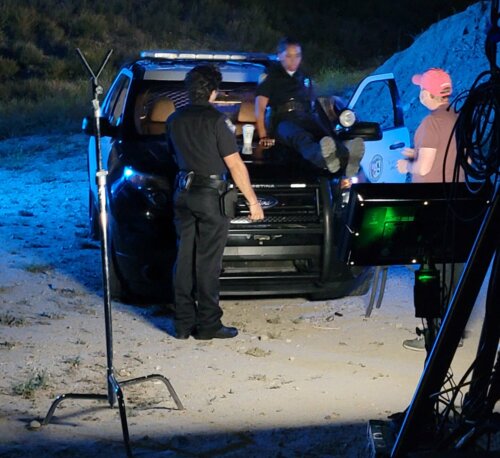 Bella Cruz, her scene partner and film crew working on a project on the beach at night.