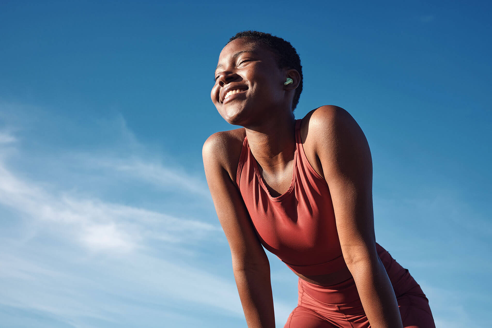 Happy woman catching her breath after a run.