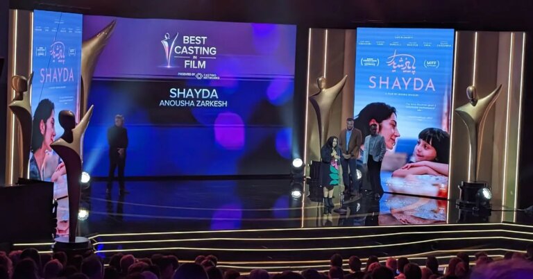 Anousha Zarkesh receives the award for Shayda on stage.