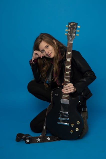 Actor Ania Thomas posing with a Gibson Les Paul.