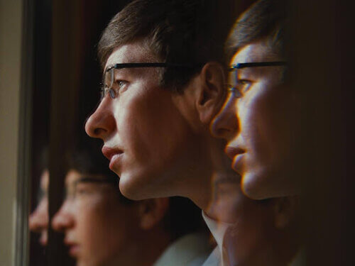 Barry Keoghan staring at a window.