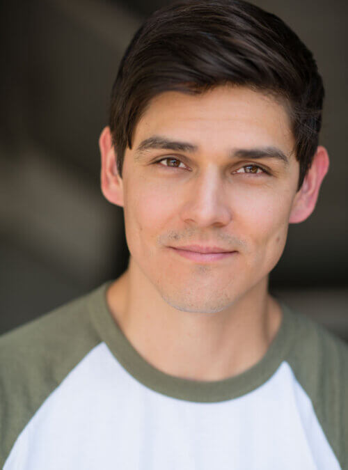 Orlando actor Bryan Bachman wearing a grey and white shirt.