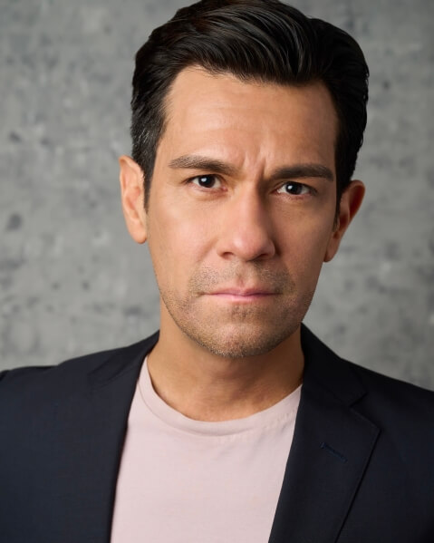 Actor David Montalvo looking serious in a blazer.