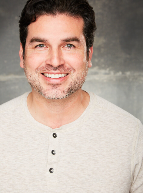 Actor Fabian Jaime smiling in a white button down shirt.