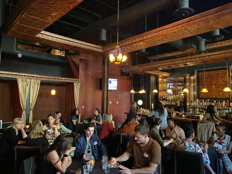 A crown of actors networking at a bar