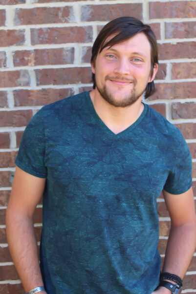 Joseph Marshall in a blue shirt smiling.