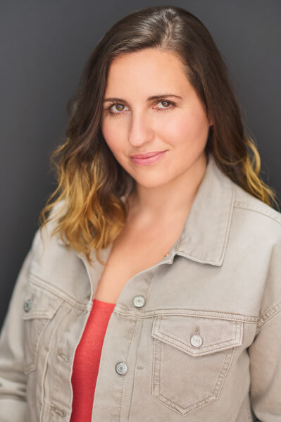 Actor Kiirstin Marilyn smiling in a denim jacket.