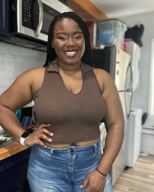 Actor Nerissa McCollin smiling inside a kitchen.