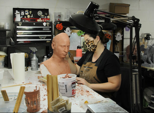 Special effects artist at her desk working on a character model.