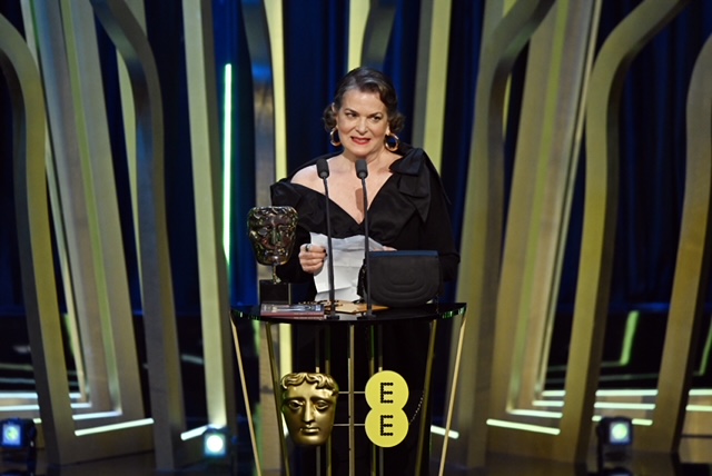 Susan Shopmaker wins the BAFTA award in a black dress.