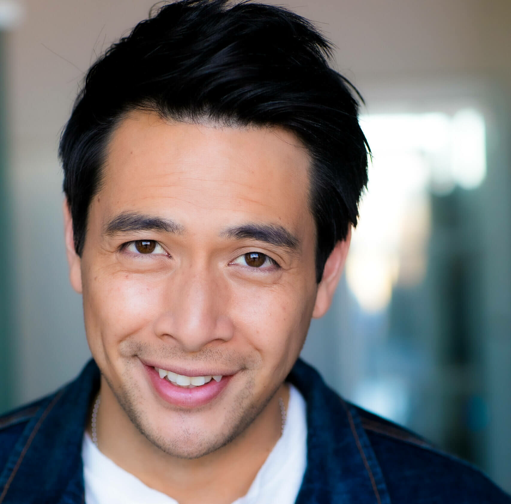 Actor Ron Nery Jr. in a denim jacket and a white shirt.