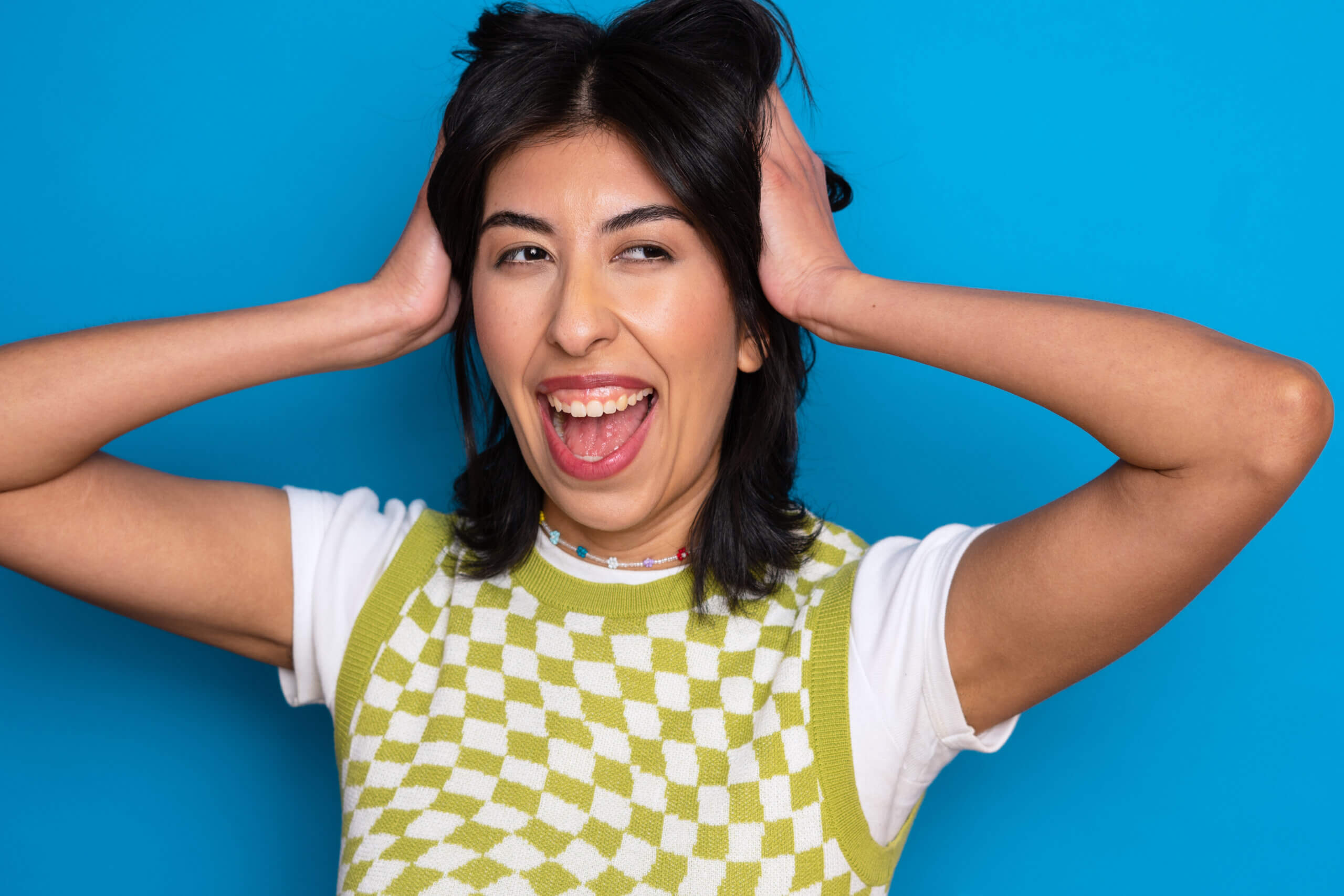 Actor Salem Rocabado making a silly face holding their hair.