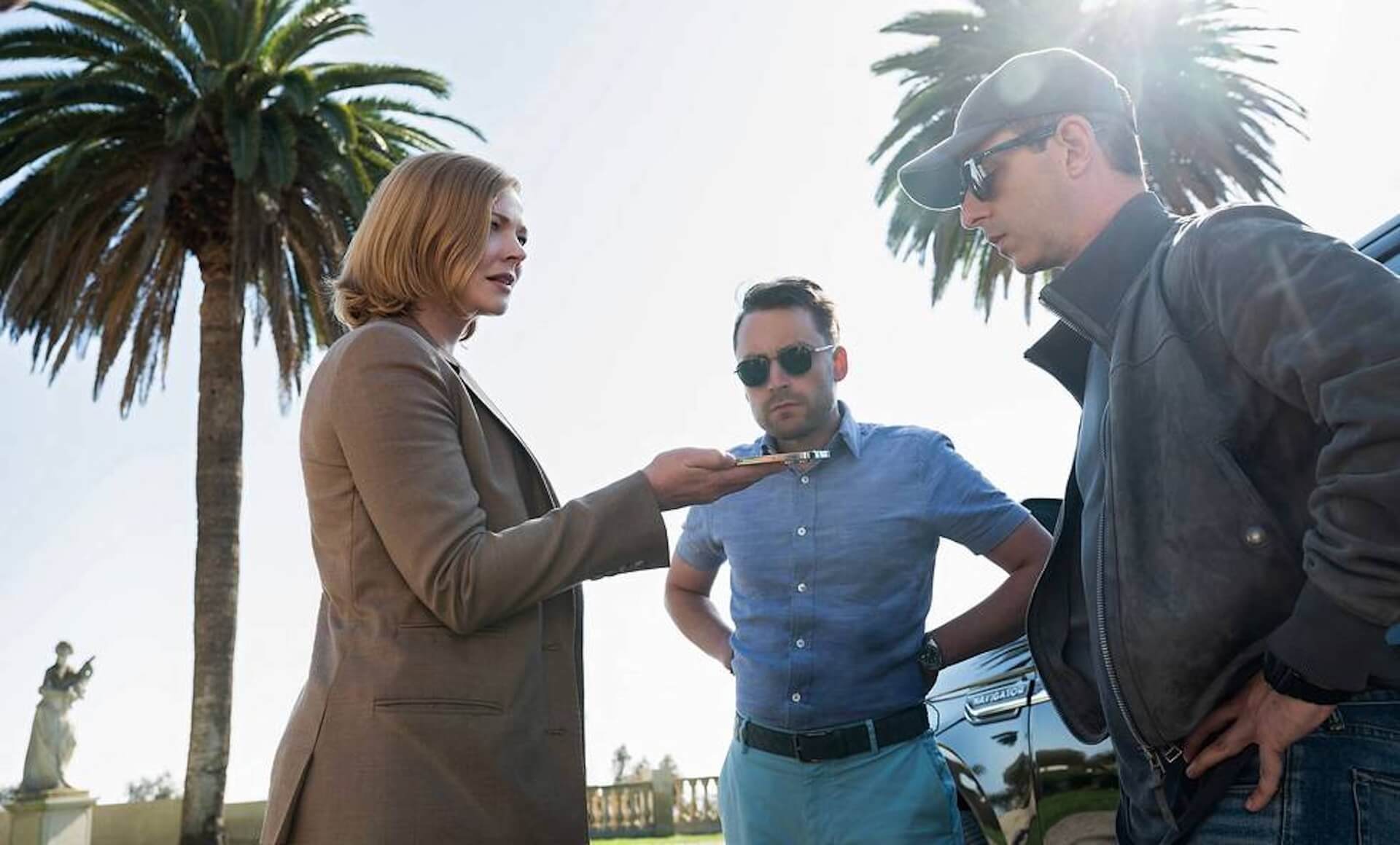 Sarah Snook, Kieran Culkin and Jeremy strong chatting outside.