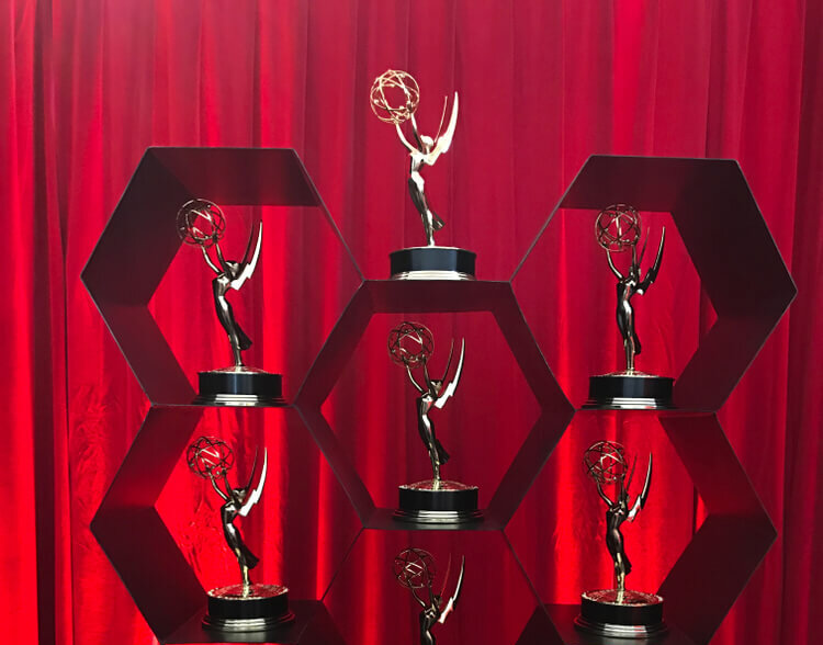 Emmy statues on a honeycomb display.