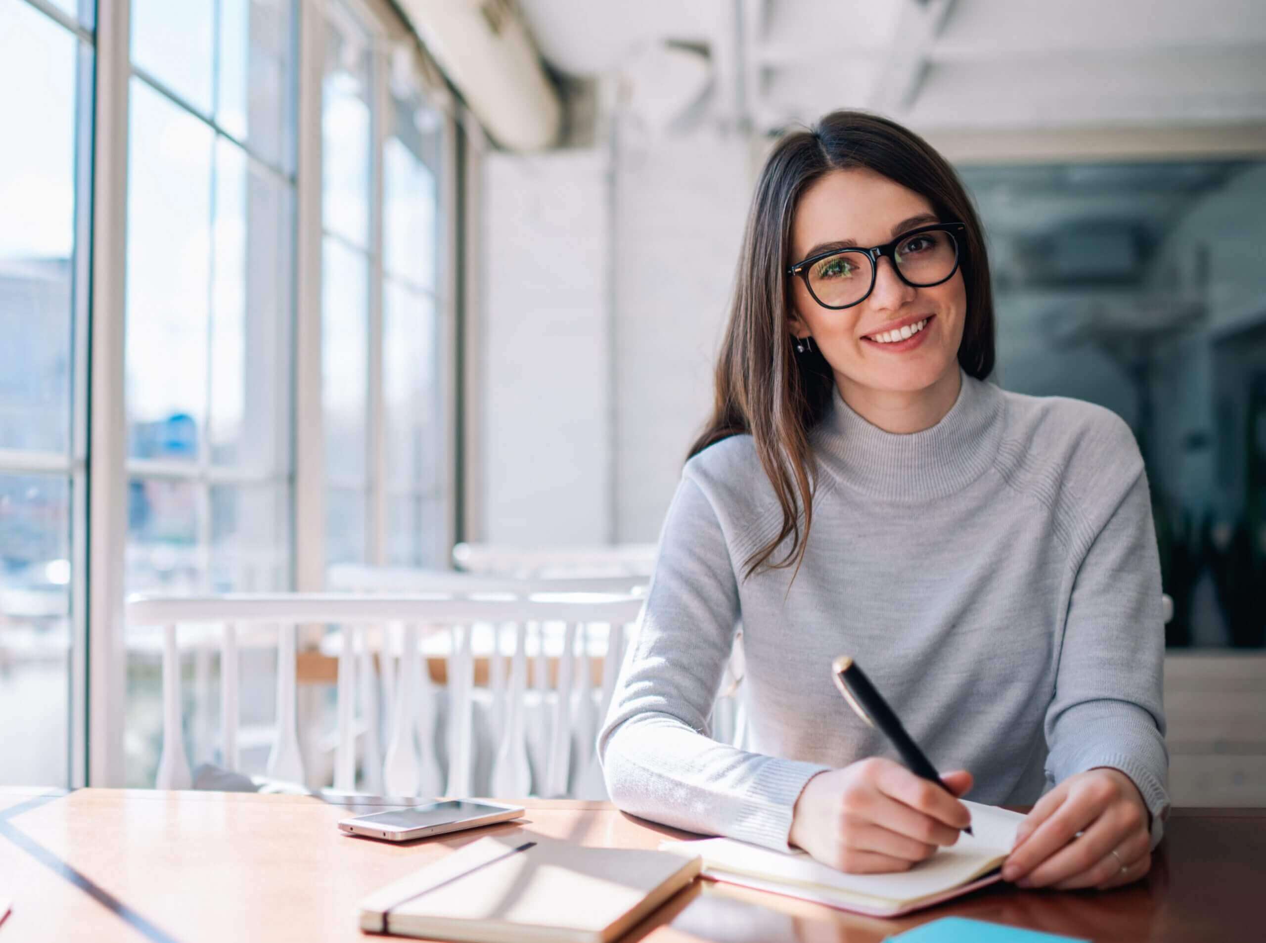 An actress jotting down multiple ways to impress a director.