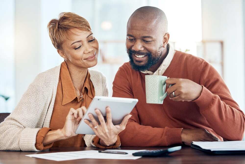 African American couple looking through their finances at home.