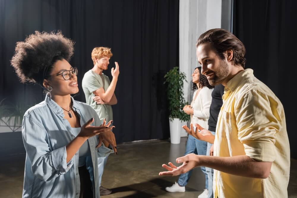 Diverse group of actors rehearsing backstage.