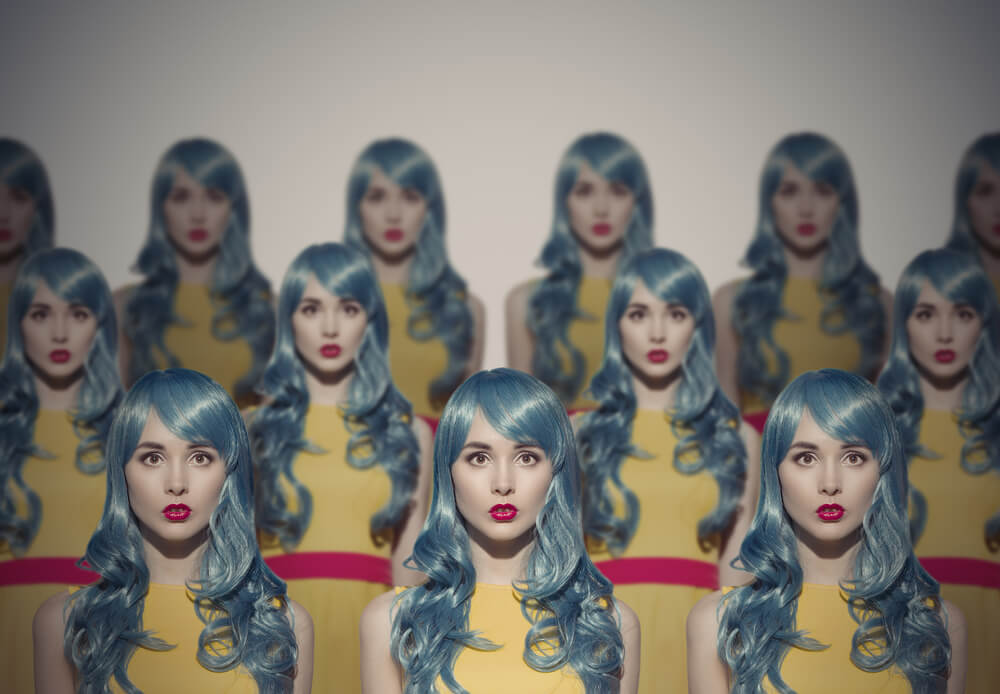 Many actresses all dressed exactly the same for a specific role: Blue hair with a yellow shirt.