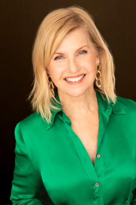 Actor Trudy Ager in a green shirt smiling.